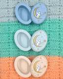 Three decorative boxes with mouse designs on a knitted fabric background