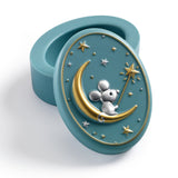 Decorative teal blue container with a mouse on a moon design on a white background