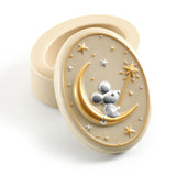 Decorative cream coloured container with a mouse on a moon design on a white background