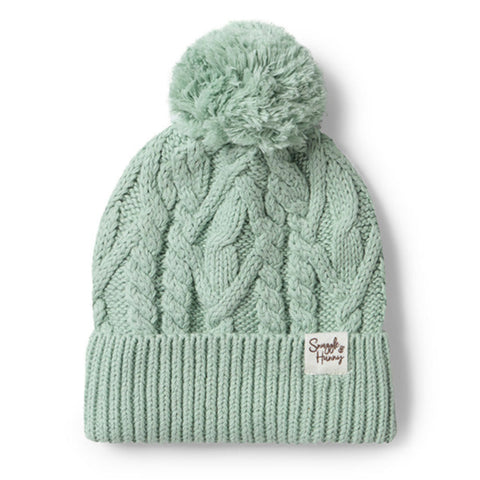 Light green knit beanie with pom-pom on a white background