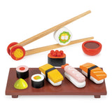 Toy sushi set with chopsticks, soy sauce, and garnishes on a white background